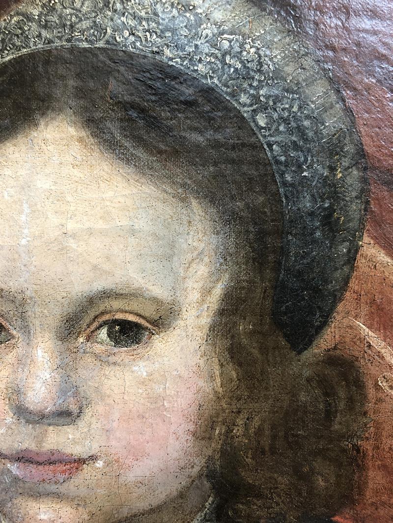 Close-up image of a child's face from the painting, showing flaking paint and cracks in the paint surface.