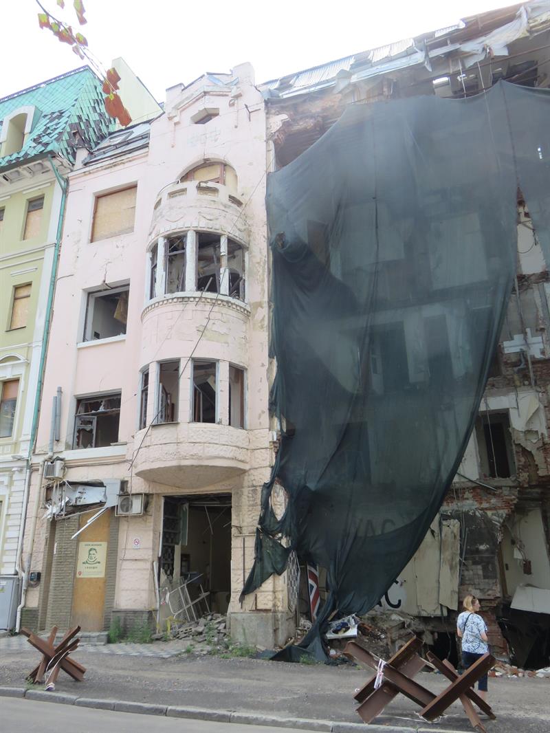 Image of netting placed over damaged parts of a building.