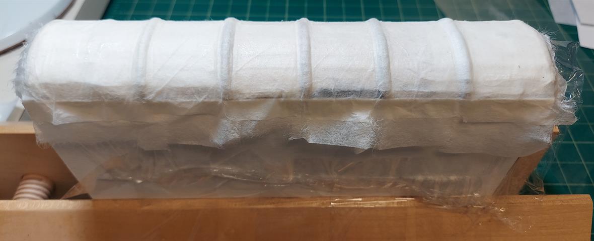 Layers of tissue hold the book spine in place during drying.