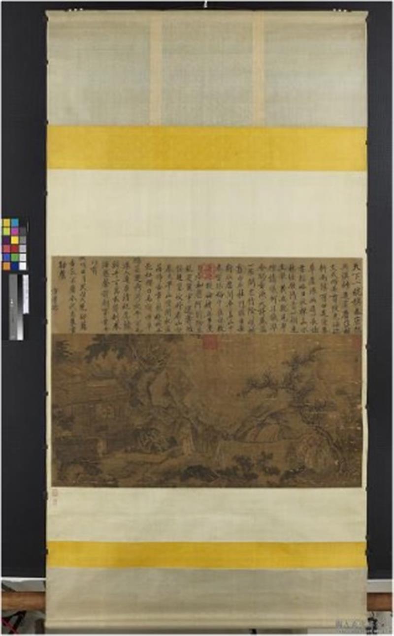 An open scroll lying flat, with the painted image surrounded by fabric borders.