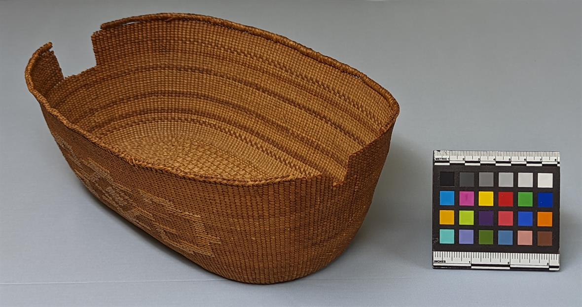 A delicate, woven basket sitting next to a digital color card used to assist with proper photography.