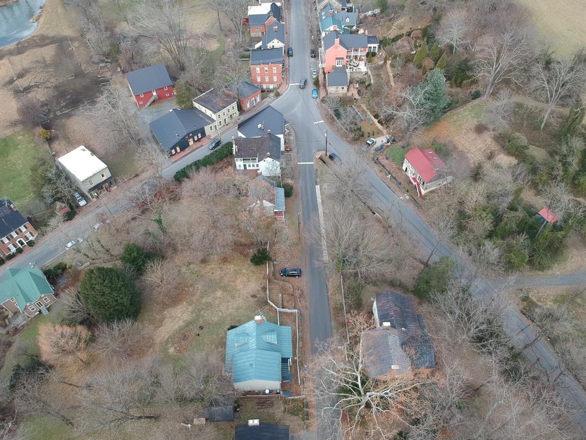 Aerial view of intersecting roads and several houses.